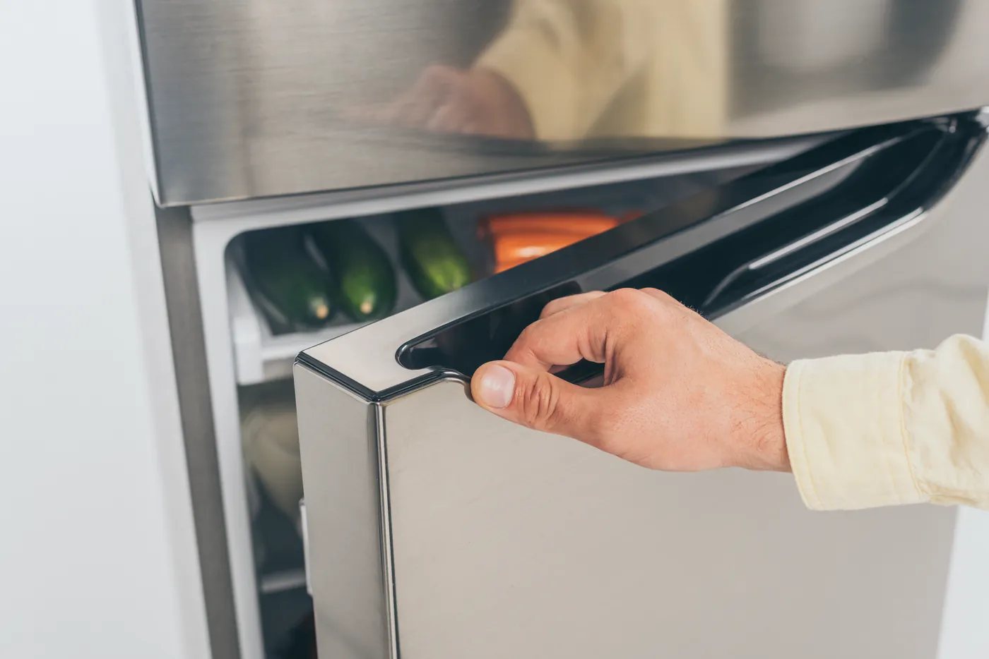 Technician diagnosing an urgent fridge fault